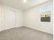 Well-lit bedroom with carpet, a window, and a closet with sliding doors at 4332 W Hannah St, San Tan Valley, AZ 85144