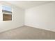 Clean, carpeted bedroom with a window providing natural light at 4332 W Hannah St, San Tan Valley, AZ 85144