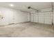 Spacious garage featuring a roll-up door and concrete flooring providing ample parking and storage space at 4332 W Hannah St, San Tan Valley, AZ 85144