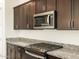 Gas range cooktop and built in microwave are some of the kitchen's features at 4332 W Hannah St, San Tan Valley, AZ 85144