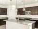 Close up view of a kitchen island with granite countertop and pendant lights at 4332 W Hannah St, San Tan Valley, AZ 85144