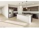 Spacious kitchen with dark cabinets, granite countertops, stainless steel appliances, and large island at 4332 W Hannah St, San Tan Valley, AZ 85144