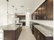 Spacious kitchen with dark cabinets, granite countertops, stainless steel appliances, and an island at 4332 W Hannah St, San Tan Valley, AZ 85144
