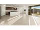 Bright, open living room with tile flooring and sliding glass doors to the backyard at 4332 W Hannah St, San Tan Valley, AZ 85144