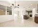 Open concept living space with tile flooring, a modern light fixture and a large kitchen island at 4332 W Hannah St, San Tan Valley, AZ 85144