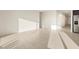 Sunlit open-concept living space with tile flooring, leading to the kitchen at 4332 W Hannah St, San Tan Valley, AZ 85144