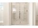 Glass enclosed shower with chrome fixtures and built-in shelves adds modern convenience to the bathroom at 4332 W Hannah St, San Tan Valley, AZ 85144