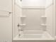 Bright bathroom showcasing a clean white shower-tub combination with built-in shelving at 4332 W Hannah St, San Tan Valley, AZ 85144