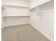 Spacious walk-in closet with carpet flooring and shelving units for maximum storage solutions at 4332 W Hannah St, San Tan Valley, AZ 85144