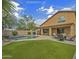 Expansive backyard with lush lawn, refreshing pool, covered patio, and comfortable seating area at 45583 W Sheridan W Rd, Maricopa, AZ 85139