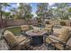 Inviting backyard featuring a pool with a waterfall and fire pit seating area, perfect for entertaining at 45583 W Sheridan W Rd, Maricopa, AZ 85139