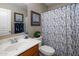Bathroom with a vanity, toilet, and shower with floral curtains at 45583 W Sheridan W Rd, Maricopa, AZ 85139