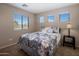 Bright bedroom with plush carpet and a comfortable bed at 45583 W Sheridan W Rd, Maricopa, AZ 85139