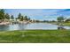 Scenic community lake with a disc golf basket and a picturesque waterfall feature at 45583 W Sheridan W Rd, Maricopa, AZ 85139