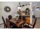 Charming dining room showcasing a decorative light fixture, wall clock, and wooden cabinets at 45583 W Sheridan W Rd, Maricopa, AZ 85139