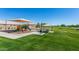 A park area with playground, picnic tables, shade covering and grassy areas at 45583 W Sheridan W Rd, Maricopa, AZ 85139