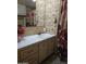 Retro bathroom featuring patterned wallpaper, a vanity with drawers, and a floral shower curtain at 5201 W Camelback Rd # Ofc, Phoenix, AZ 85031
