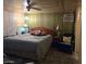 Cozy bedroom with a classic bed frame, ceiling fan, and window AC unit at 5201 W Camelback Rd # Ofc, Phoenix, AZ 85031