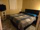 Comfortable bedroom featuring a patterned quilt, dark wood furniture, and a television at 5201 W Camelback Rd # Ofc, Phoenix, AZ 85031