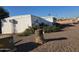 A single-story home with desert landscaping and a unique tree stump feature in the yard at 5201 W Camelback Rd # Ofc, Phoenix, AZ 85031