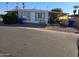 Charming single-story home with a carport and well-maintained landscaping in a mobile home community at 5201 W Camelback Rd # Ofc, Phoenix, AZ 85031