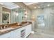 Well-lit bathroom featuring dual sinks with granite countertops and glass-enclosed shower at 5431 E Lafayette Blvd, Phoenix, AZ 85018