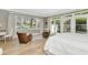 Sunlit bedroom with hardwood floors, cozy seating area, and french doors to the backyard at 5431 E Lafayette Blvd, Phoenix, AZ 85018