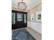 Elegant foyer with brick floors, dark wood door with glass panes, and views of the front yard at 5431 E Lafayette Blvd, Phoenix, AZ 85018