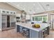 Well-appointed kitchen with large island, stainless appliances, pendant lights, and farmhouse sink at 5431 E Lafayette Blvd, Phoenix, AZ 85018