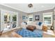 Inviting living room with a large sectional sofa, blue rug, and french doors at 5431 E Lafayette Blvd, Phoenix, AZ 85018