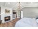 Spacious main bedroom with a fireplace, chandelier, and access to the ensuite bathroom via barn door at 5431 E Lafayette Blvd, Phoenix, AZ 85018