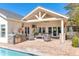 A covered patio featuring an outdoor kitchen, comfortable seating, and a view of the pool at 5431 E Lafayette Blvd, Phoenix, AZ 85018