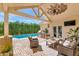 Inviting covered patio features a built-in grill, lounge furniture, and refreshing pool view at 5431 E Lafayette Blvd, Phoenix, AZ 85018