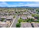 Wide aerial shot showcasing the neighborhood, mountains in distance, and manicured yards at 604 W Villa Rita Dr, Phoenix, AZ 85023