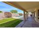 Covered patio offering a view of the pool with rock waterfall feature and privacy fencing at 604 W Villa Rita Dr, Phoenix, AZ 85023