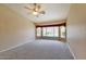 Spacious bedroom featuring plush carpet, ceiling fan, and windows overlooking the pebble tec pool with rock waterfall at 604 W Villa Rita Dr, Phoenix, AZ 85023