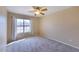 Cozy bedroom with neutral walls, carpet, window with curtains, and a ceiling fan at 604 W Villa Rita Dr, Phoenix, AZ 85023