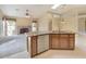Bright kitchen features granite countertops, stainless steel dishwasher, tile floors, and seamless flow into the living room at 604 W Villa Rita Dr, Phoenix, AZ 85023