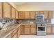 Updated kitchen with granite countertops, stainless steel appliances, and wooden cabinets at 604 W Villa Rita Dr, Phoenix, AZ 85023