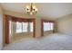 Bright living room featuring comfortable carpet, ample windows for natural light, and tasteful drapery at 604 W Villa Rita Dr, Phoenix, AZ 85023