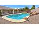 Inviting backyard pool with rock accents, surrounded by a fence and mature landscaping, perfect for relaxation and entertainment at 604 W Villa Rita Dr, Phoenix, AZ 85023