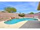 Beautiful backyard pool with rock waterfall feature and privacy wall at 604 W Villa Rita Dr, Phoenix, AZ 85023