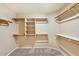 Spacious walk-in closet with custom shelving and hanging rods for ample storage at 604 W Villa Rita Dr, Phoenix, AZ 85023