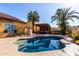Beautiful backyard with a sparkling pool, a pergola, and lush landscaping, perfect for outdoor living at 6820 W Angela Dr, Glendale, AZ 85308
