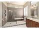 Modern bathroom with a large tiled shower, bench, and sleek vanity at 6820 W Angela Dr, Glendale, AZ 85308