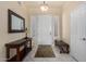 Inviting entryway with tiled floors, a console table, a mirror and a bench at 6820 W Angela Dr, Glendale, AZ 85308