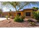 Charming single-story home features desert landscaping, a two-car garage and a tiled roof at 6820 W Angela Dr, Glendale, AZ 85308