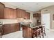 Another view of the kitchen featuring a center island, stainless steel appliances, and dark wood cabinets at 6820 W Angela Dr, Glendale, AZ 85308