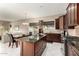 Modern kitchen with dark wood cabinets, granite countertops, stainless steel appliances, and an island at 6820 W Angela Dr, Glendale, AZ 85308