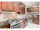 Another view of the kitchen featuring stainless steel appliances and dark wood cabinets at 6820 W Angela Dr, Glendale, AZ 85308